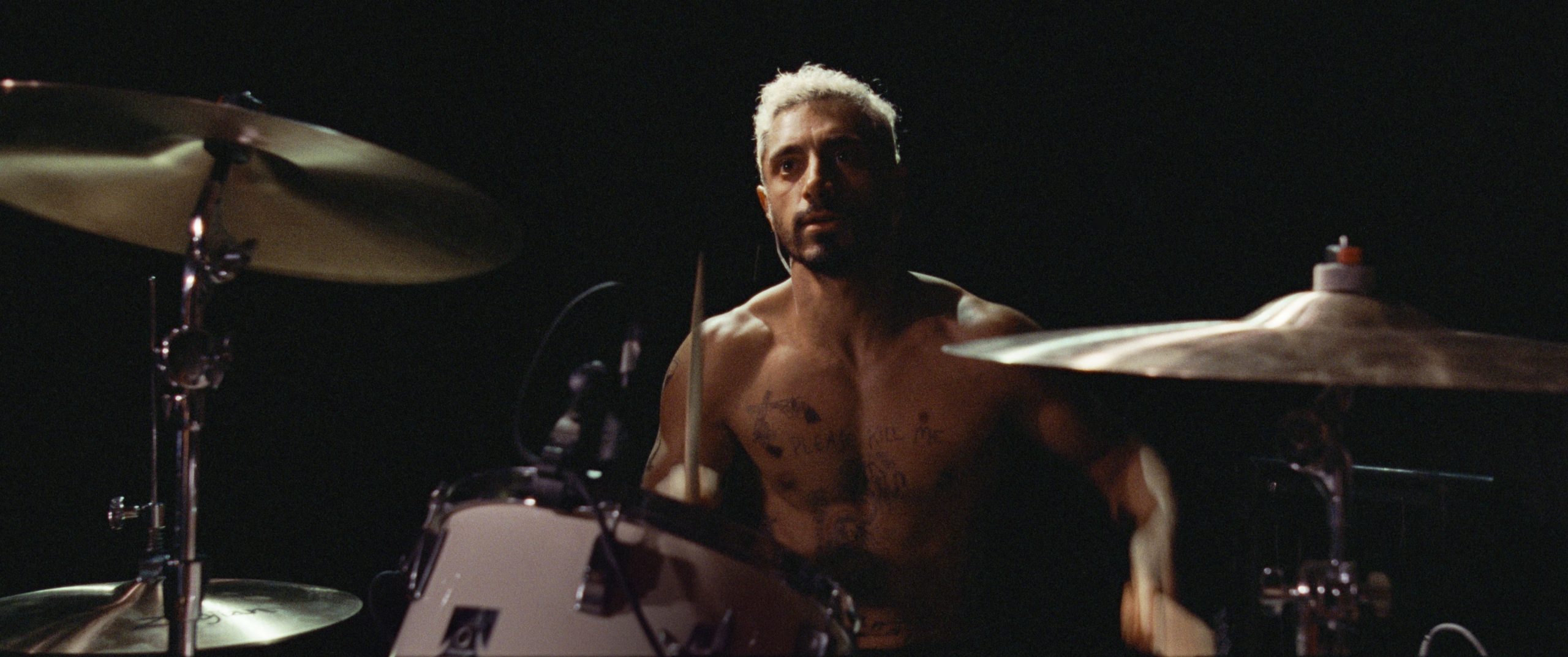 Image of Asian male playing drums, official photo from the film Sound of Metal
