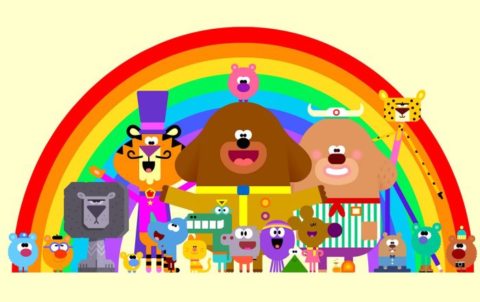 A promotional picture of animated children's show Hey Duggee - animals in clothes stand in front of a rainbow.