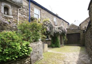 an old cottage in Dent with a cobble stone floor outside
